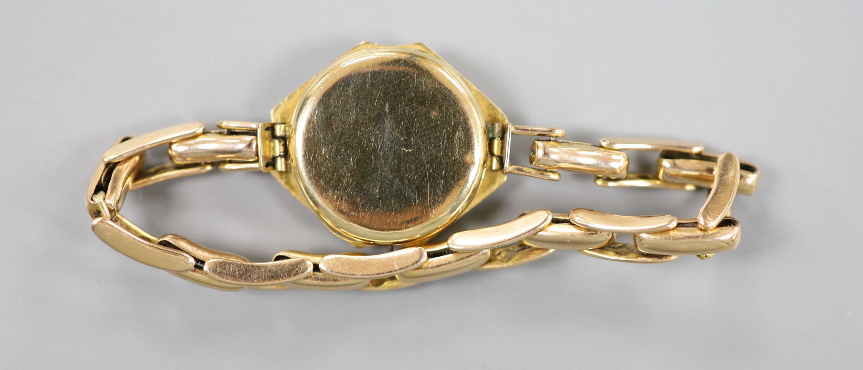 A lady's 18ct gold manual wind wrist watch(a.f.), on a 15ct expanding bracelet